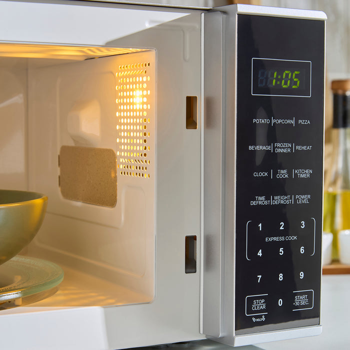 Microwave oven with digital display and control panel, showing the time '00:05'.