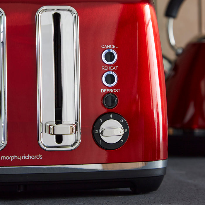 Red toaster with control buttons on a blurred kitchen background