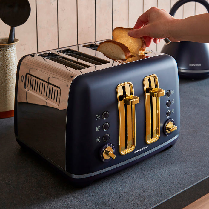 Blue toaster with gold accents on a kitchen counter, being used to toast bread.