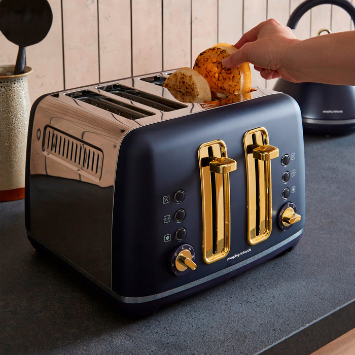 Blue toaster with gold accents on a kitchen counter, being used to toast bread.