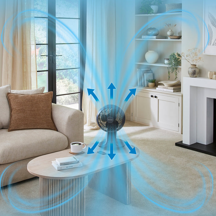 Fan blowing air in a living room with arrows indicating airflow