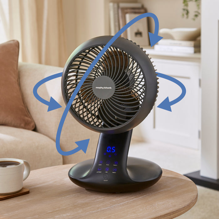 Tabletop fan on a coffee table with a living room background