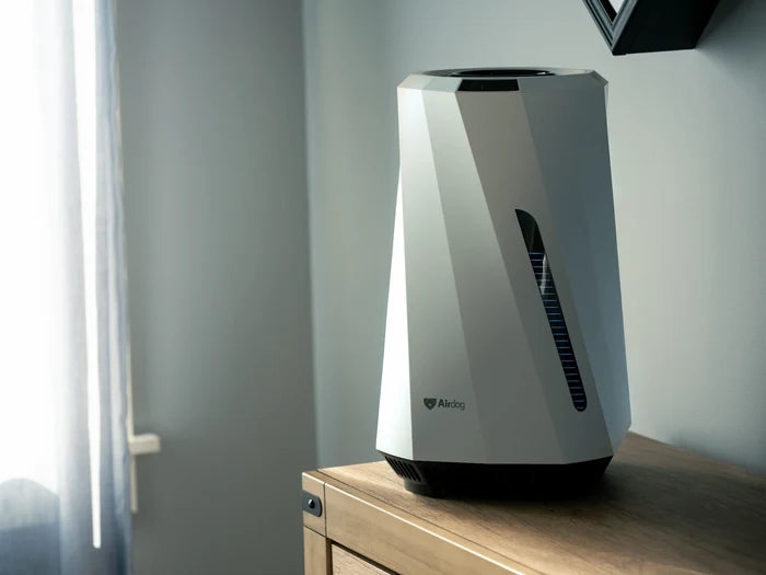 Airdog Air purifier on a wooden surface with a neutral background