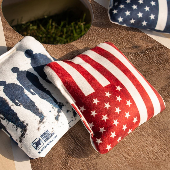 American Flag Red Lock Shot Cornhole Bag resting on an ACA cornhole board before gameplay, designed for control, blocking, and keeping more bags on the 
board.
#color_red