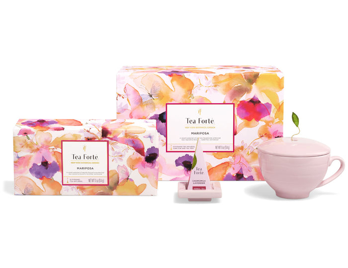 Tea Forte Mariposa combo set with pink teacup, two boxed tea packages with floral design, and tea infuser.