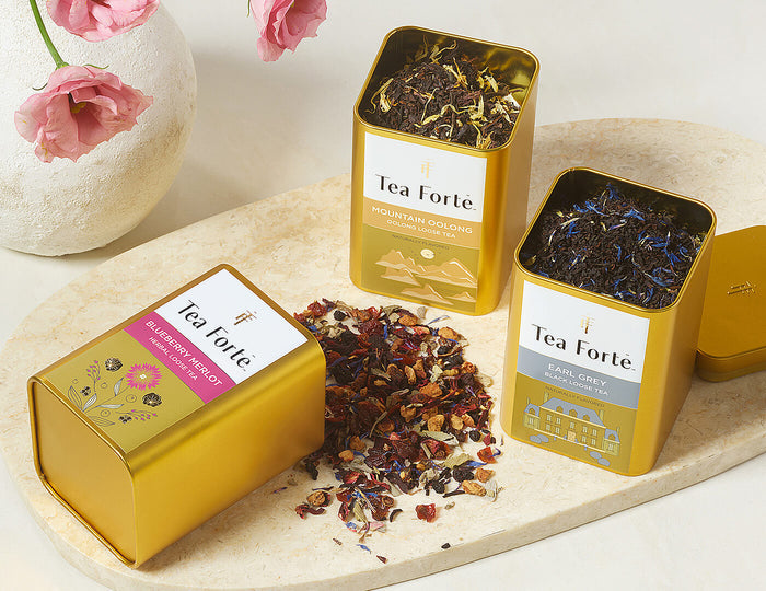 3 Loose leaf tea canisters, one spilling out loose leaf tea