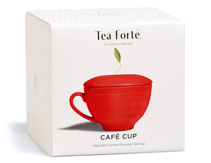 Ruby red porcelain tea cup with matching lid and handle, displayed on white Tea Forte packaging box.