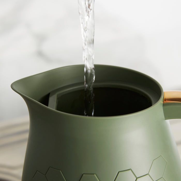 water pouring into green kettle