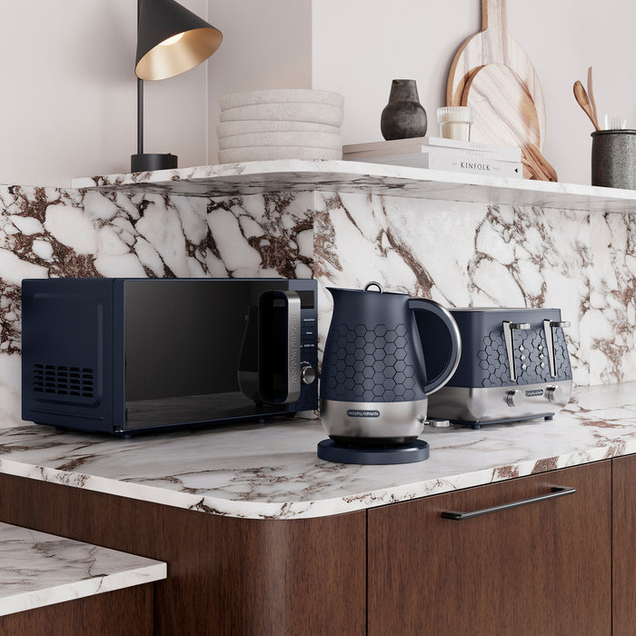 Kitchen counter with Morphy Ruchards Cassini microwave, kettle, and toaster on a marble countertop.
