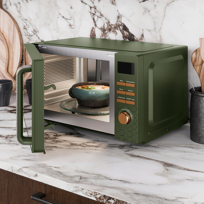 Green microwave oven on a marble countertop with a bowl inside