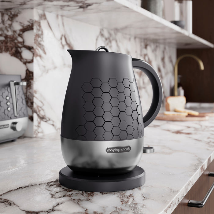 Black Kettle on marble counter top in kitchen.