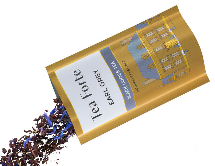 Tea Forte Earl Grey single steeps pouch with loose tea spilling out on a white background