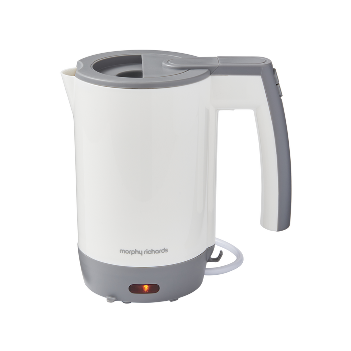 A white Morphy Richards compact travel kettle with a gray handle and base, featuring a boil-dry protection switch and a power indicator light.