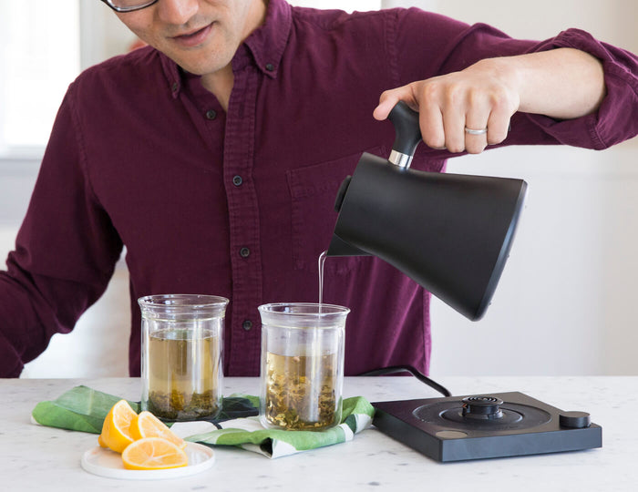 Pouring hot water into tea glasses from the Black Corvo Kettle EKG Pro