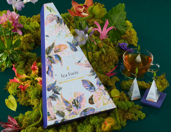 MAIN PDP | Demoiselle 12 days of Teas box with a teacup and tea infusers in a layer of moss and flowers