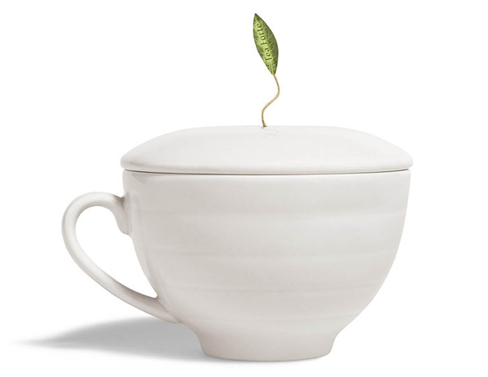 White ceramic teacup with matching lid topped by a green leaf-shaped finial.