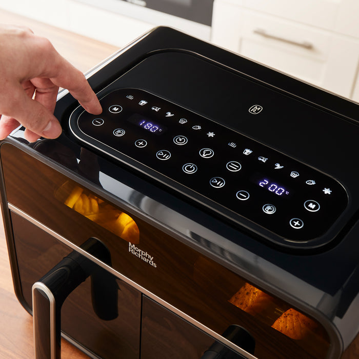 hand selecting setting on air fryer control panel