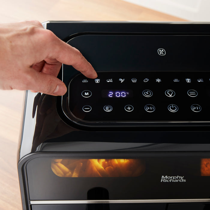 hand selecting setting on air fryer control panel