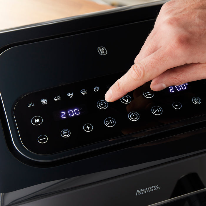 hand selecting setting on air fryer control panel