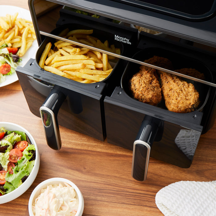 dual air fryers drawers filled with chips and breaded chicken