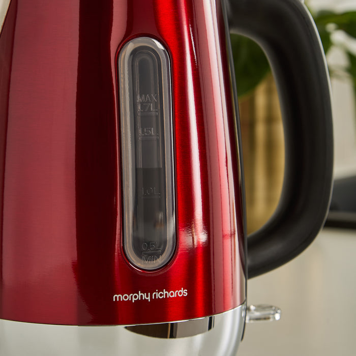 Red Morphy Richards kettle with a black handle on a blurred background