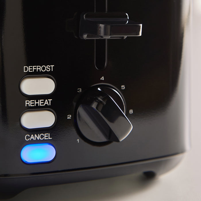 Control panel of a toaster with buttons labelled 'Defrost', 'Reheat', 'Cancel' and a blue indicator light.