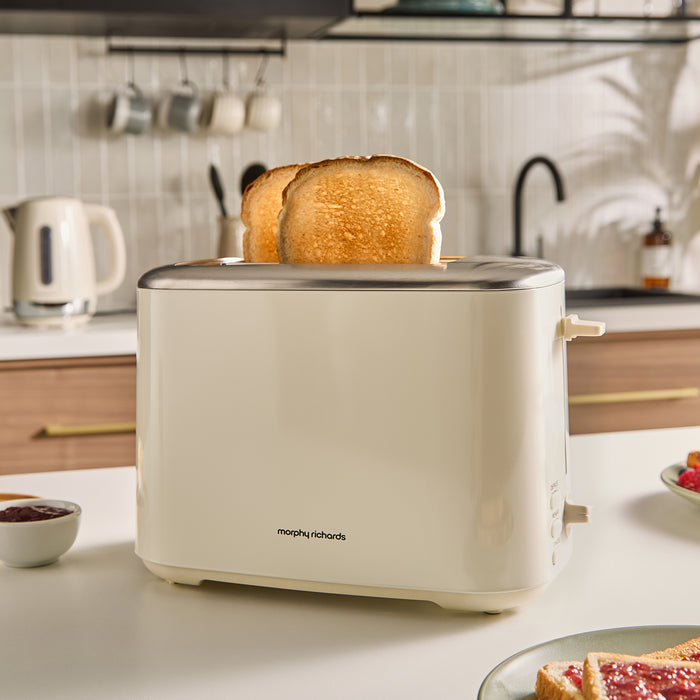 Beige toaster with slices of toast on a kitchen counter
