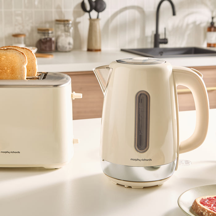 Beige kettle and toaster on a kitchen counter with a blurred background