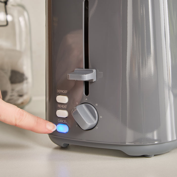 Person pressing a button on a 2 slice toaster with visible buttons.