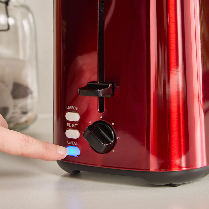 Red toaster with control buttons being pressed by a hand