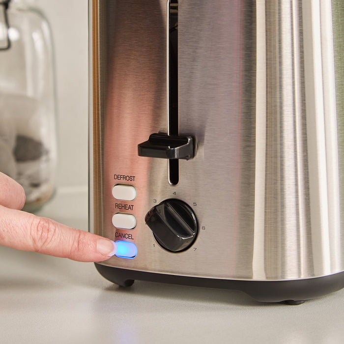 Person pressing a button on a stainless steel toaster with control panel.