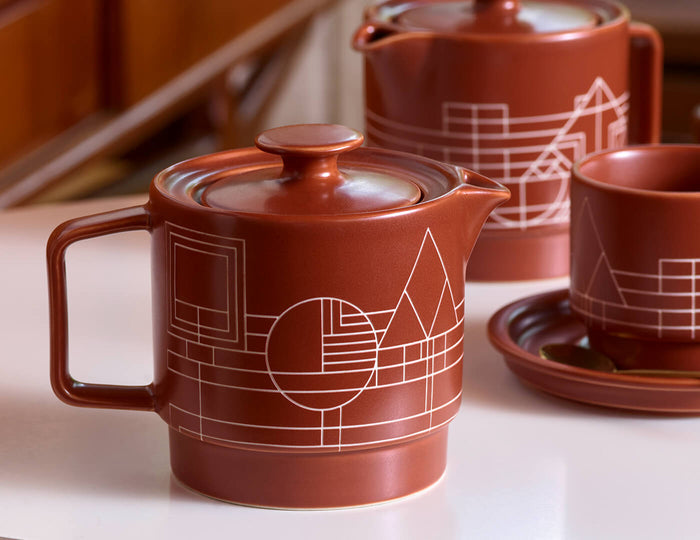 MAIN PDP | Terra stoneware teapot and infuser on a table with other Terra accesories