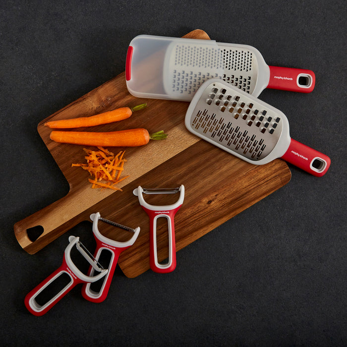 Grater and Peeler Set on a wooden chopping baord