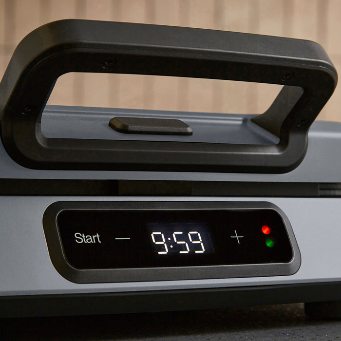 Digital clock with timer display on a device, showing time '9:59'.