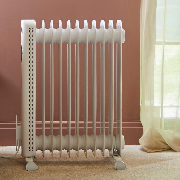 White radiator against a brown wall with a window in the background
