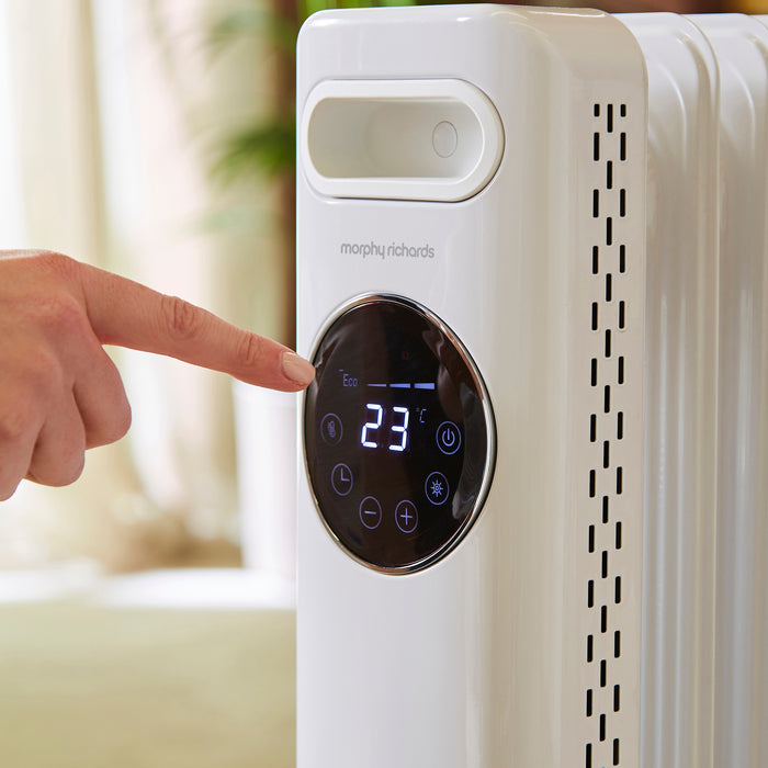 Person adjusting the temperature on a Morphy Richards radiator.
