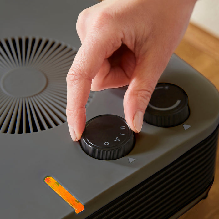 Hand adjusting knobs on a heater