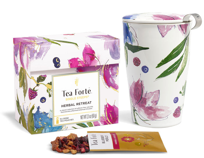 Tea Forte herbal tea set with floral design on packaging and mug.