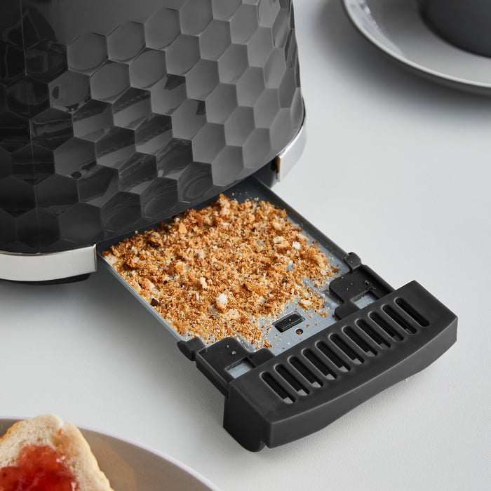 black toaster crumb tray puled out to show crumbs