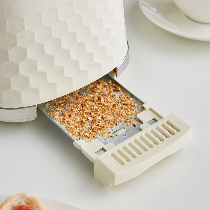 Cream toaster with crumb tray on a light surface