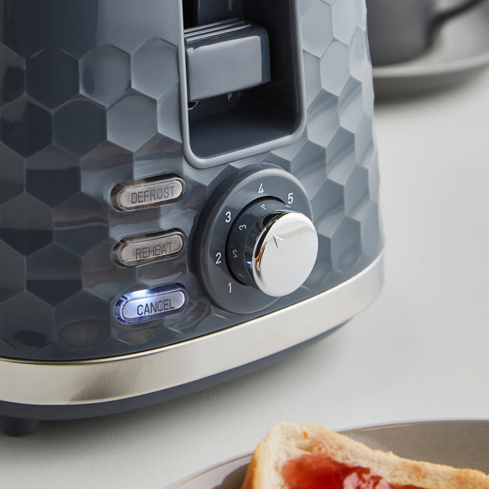 Grey toaster with control knob on a kitchen counter