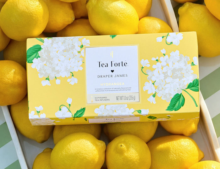 MAIN PDP | Hydrangea Petite Presentation Box, closed, laying on top of lemons