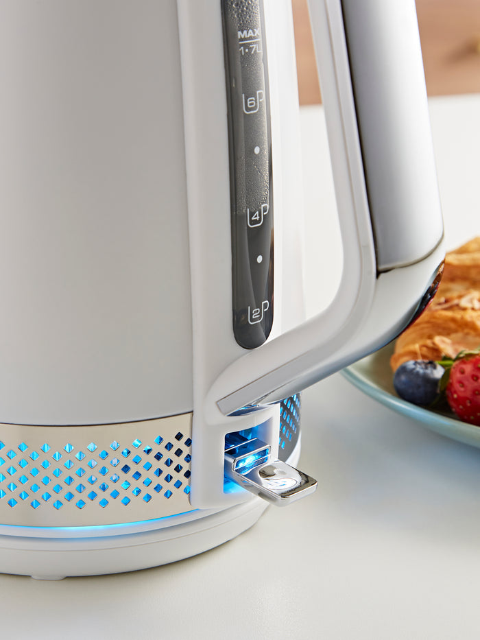 White electric kettle with control handle on a kitchen counter