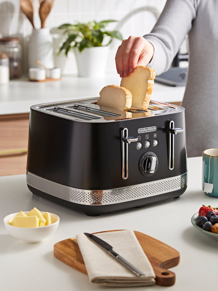 Black toaster with slices of bread on a kitchen counter