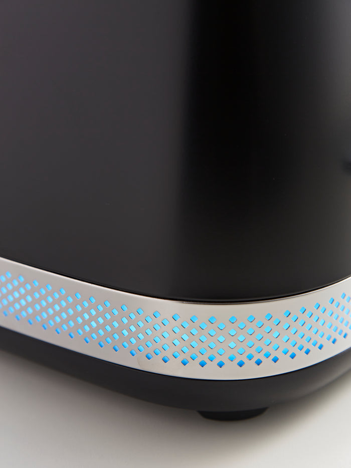 Close-up of a black electronic device with blue LED lights on a white background