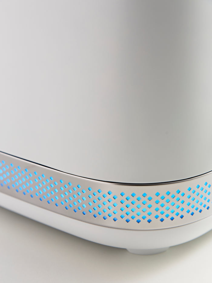 Close-up of a white electronic device with blue LED lights