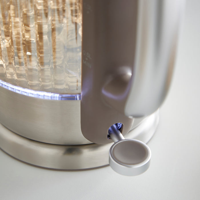 Close-up of a metallic lamp with a decorative shade on a white background