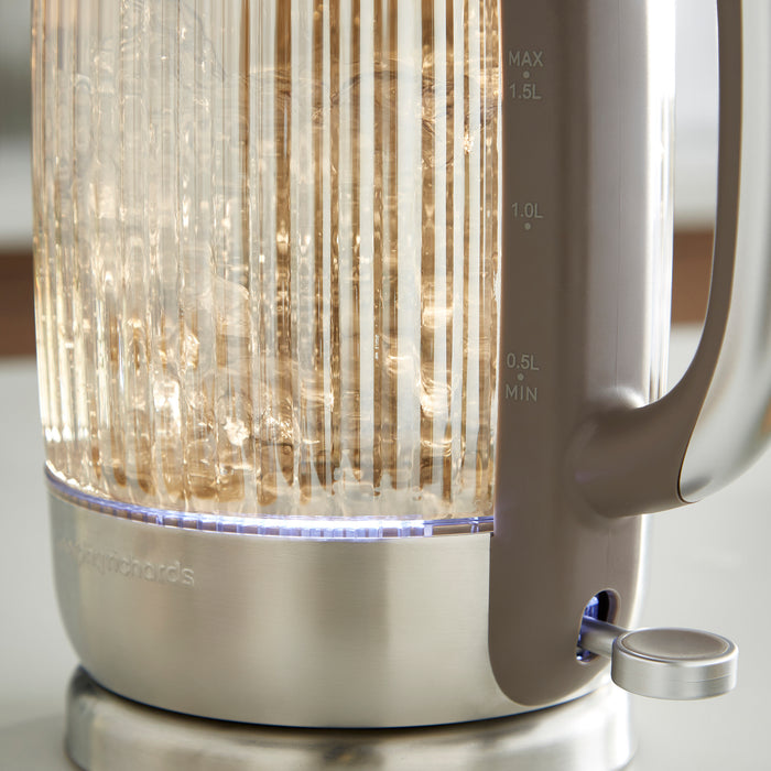 Modern electric kettle with glass liner on a neutral background