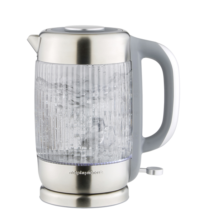 Clear glass electric kettle with silver base and handle on a white background