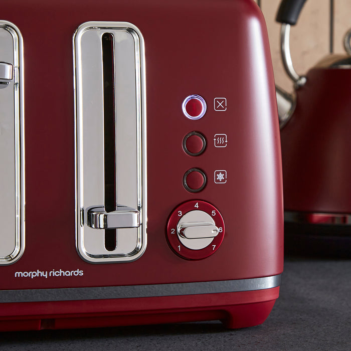 Red toaster with control panel and Morphy Richards branding on a dark surface.